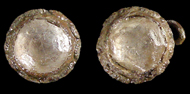 Clear conical faceted glass jewels in copper alloy settings with decorative rims.